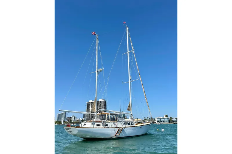 Scout (name Reserved) Yacht Photos Pics Sailboat Alden Boothbay Explorer 1971 on water with clear blue sky background.