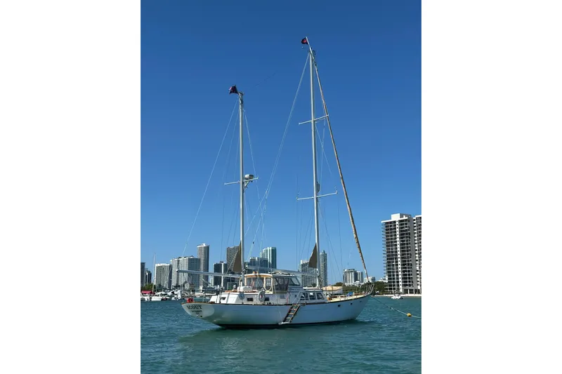 Scout (name Reserved) Yacht Photos Pics Sailboat Alden Boothbay Explorer 1971 on water with city skyline background.