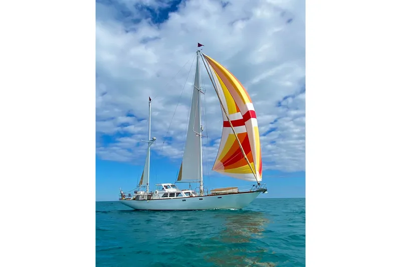 Scout (name Reserved) Yacht Photos Pics 1971 Alden Boothbay Explorer sailboat with colorful sails on open sea under blue sky.