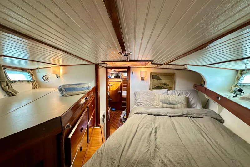 Scout (name Reserved) Yacht Photos Pics Cozy cabin interior of 1971 Alden Boothbay Explorer yacht with bed and wooden furnishings.