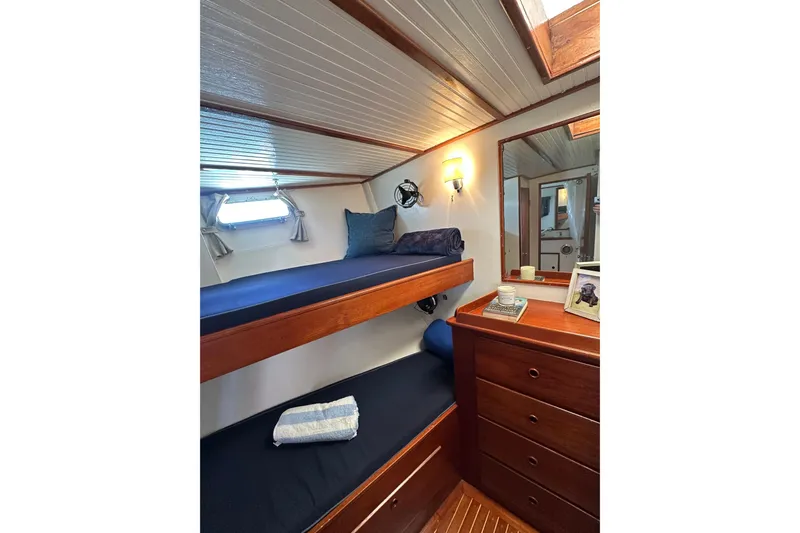 Scout (name Reserved) Yacht Photos Pics Interior of 1971 Alden Boothbay Explorer yacht with wooden bunk beds and dresser.