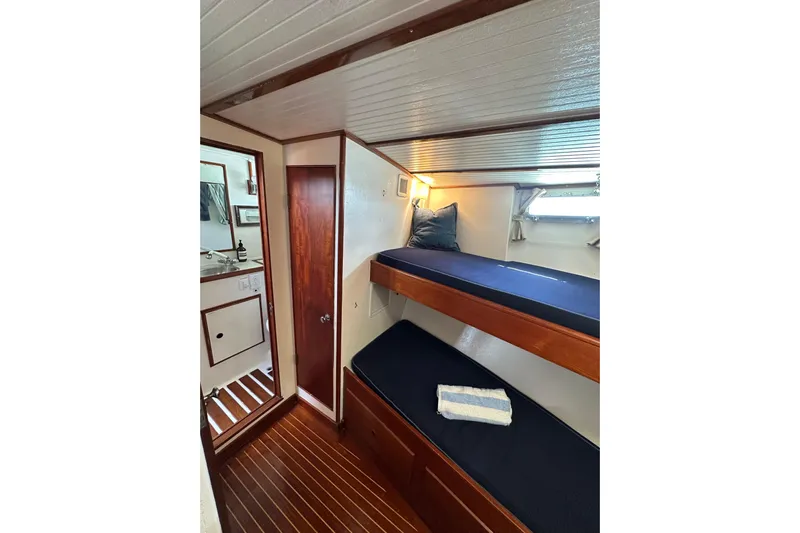 Scout (name Reserved) Yacht Photos Pics Interior of 1971 Alden Boothbay Explorer with wooden bunk beds and nautical decor.