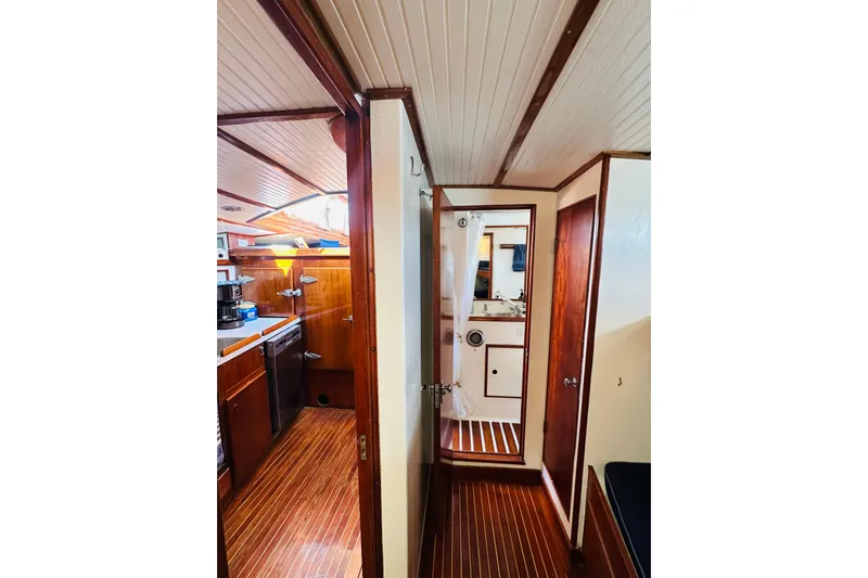 Scout (name Reserved) Yacht Photos Pics Interior of 1971 Alden Boothbay Explorer yacht with wooden finishes and compact kitchen.