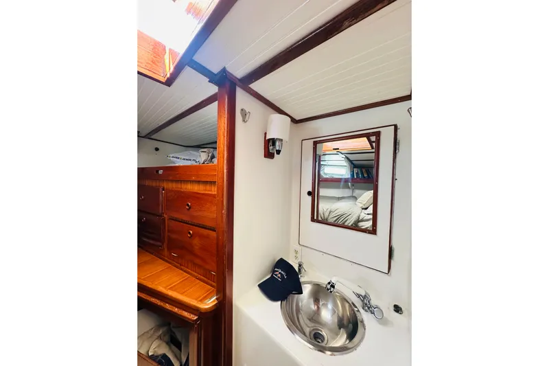Scout (name Reserved) Yacht Photos Pics Interior of 1971 Alden Boothbay Explorer yacht with wooden cabinetry and stainless steel sink.