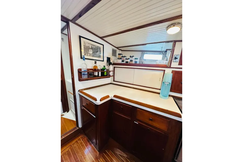 Scout (name Reserved) Yacht Photos Pics 1971 Alden Boothbay Explorer yacht interior with wooden cabinetry and countertop.