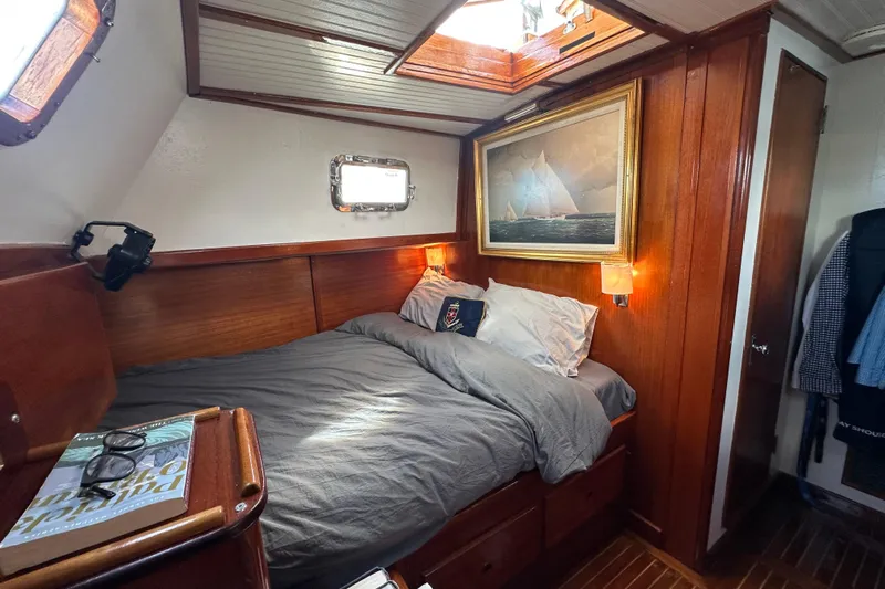 Scout (name Reserved) Yacht Photos Pics Cozy cabin interior of 1971 Alden Boothbay Explorer with wood paneling and nautical decor.