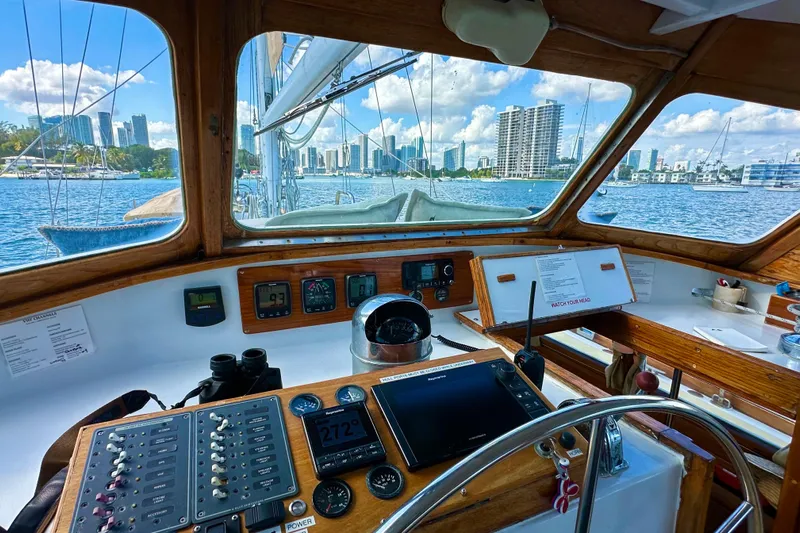 Scout (name Reserved) Yacht Photos Pics Interior view of 1971 Alden Boothbay Explorer sailboat cockpit with city skyline.