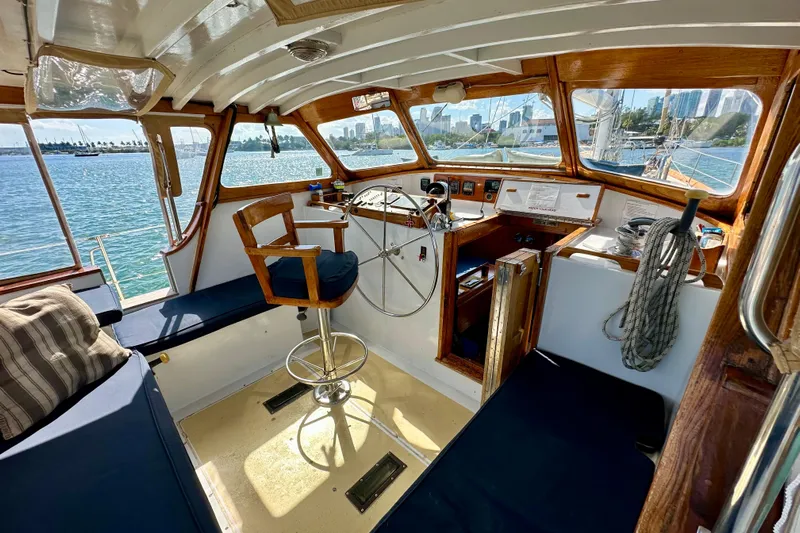 Scout (name Reserved) Yacht Photos Pics Interior of 1971 Alden Boothbay Explorer boat with wooden helm and ocean view.