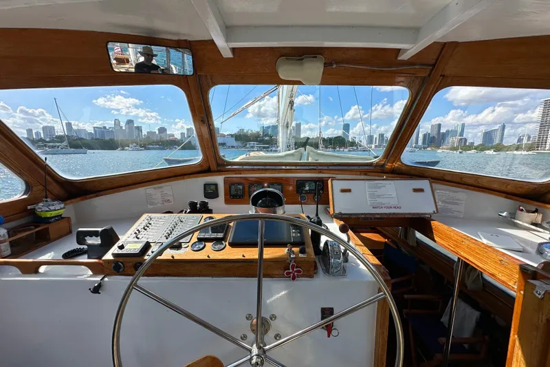 Scout (name Reserved) Yacht Photos Pics Interior view of 1971 Alden Boothbay Explorer yacht cockpit with city skyline in background.