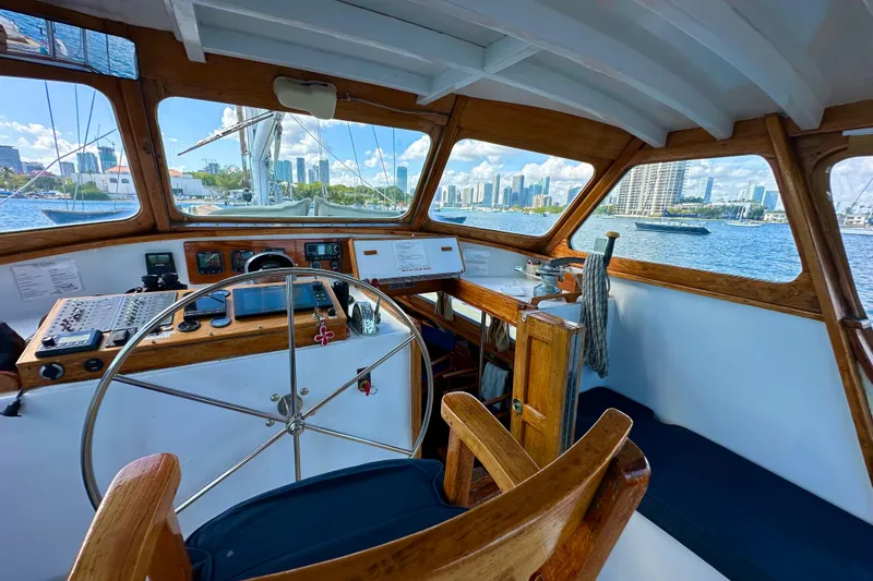 Scout (name Reserved) Yacht Photos Pics Interior view of 1971 Alden Boothbay Explorer boat with city skyline in background.