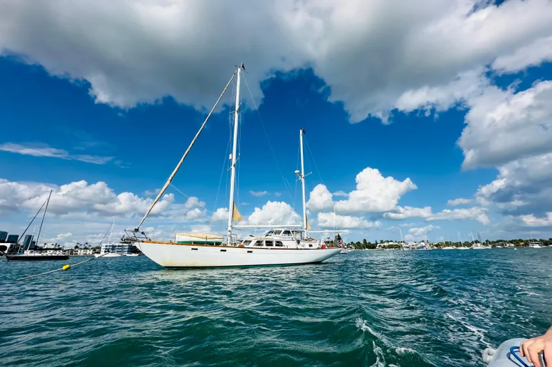 Scout (name Reserved) Yacht Photos Pics Sailboat Alden Boothbay Explorer 1971 on blue ocean under cloudy sky.