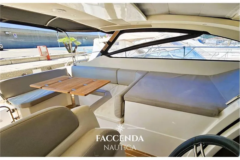  Yacht Photos Pics Interior of 2013 Azimut Atlantis 44 yacht with seating and table, docked at marina.