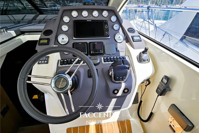 Yacht Photos Pics Cockpit of 2013 Azimut Atlantis 44 yacht with steering wheel and control panel.