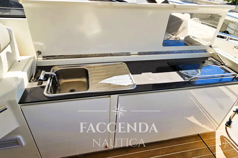  Yacht Photos Pics Outdoor kitchenette on 2013 Azimut Atlantis 44 yacht with sink and stove.