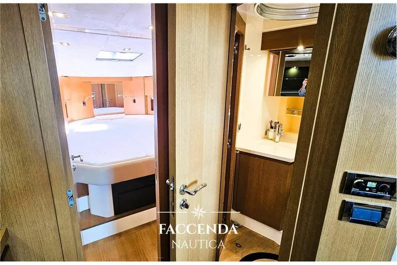  Yacht Photos Pics Luxurious interior of 2013 Azimut Atlantis 44 yacht, featuring a cozy bedroom and modern bathroom.