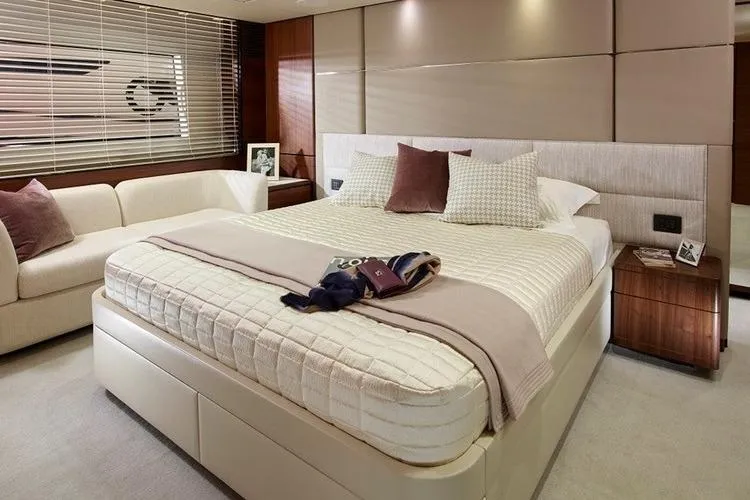  Yacht Photos Pics Luxurious bedroom interior on a 2016 Princess 75 yacht, featuring elegant decor and comfortable furnishings.