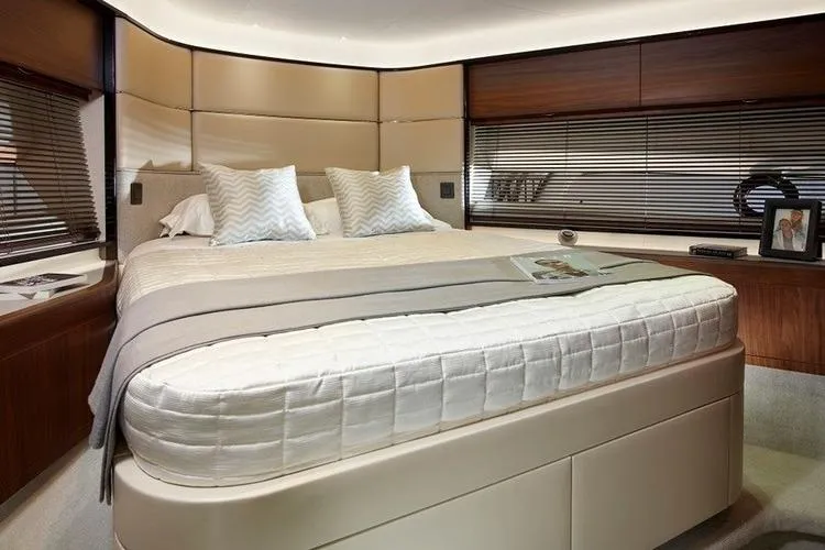  Yacht Photos Pics Luxurious bedroom interior of 2016 Princess 75 yacht with modern decor and cozy bedding.