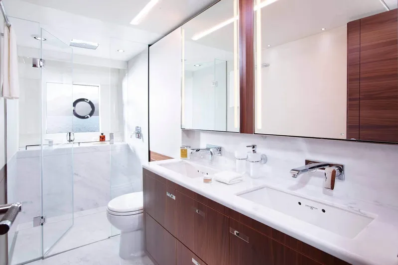  Yacht Photos Pics Luxurious yacht bathroom with dual sinks, glass shower, and ocean view, Princess 75, 2016 model.