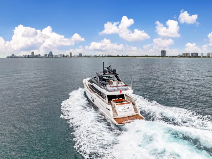 Sand Yacht Photos Pics Sanlorenzo SL78 yacht cruising on open water, 2018 model, city skyline in background.