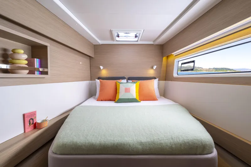  Yacht Photos Pics Luxurious cabin interior of 2025 Lagoon 43 yacht with modern decor and scenic window view.