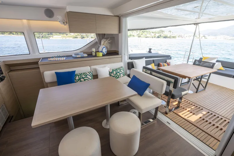  Yacht Photos Pics Luxurious interior of 2025 Lagoon 43 yacht with modern dining area and scenic ocean view.