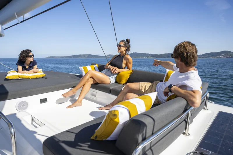  Yacht Photos Pics People relaxing on a 2025 Lagoon 43 yacht, enjoying a sunny day at sea.
