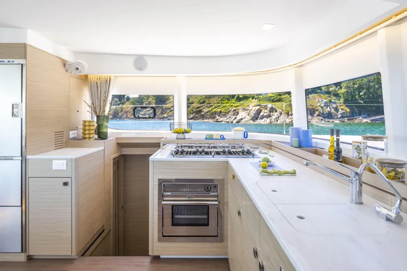  Yacht Photos Pics Modern kitchen interior on 2025 Lagoon 43 yacht with scenic ocean view.