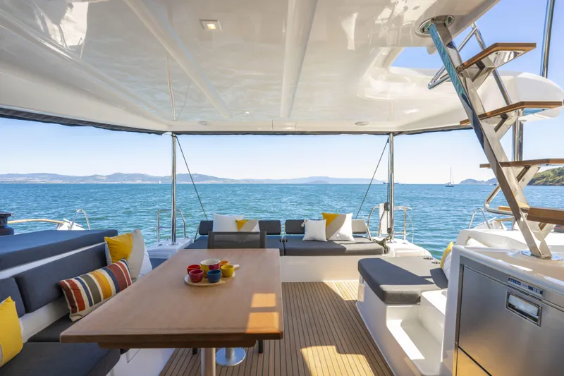  Yacht Photos Pics Luxurious Lagoon 43 yacht interior with ocean view, featuring modern seating and vibrant cushions.