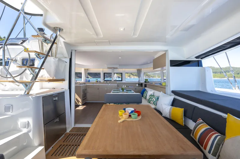  Yacht Photos Pics Luxurious interior of 2025 Lagoon 43 yacht with modern kitchen and seating area.