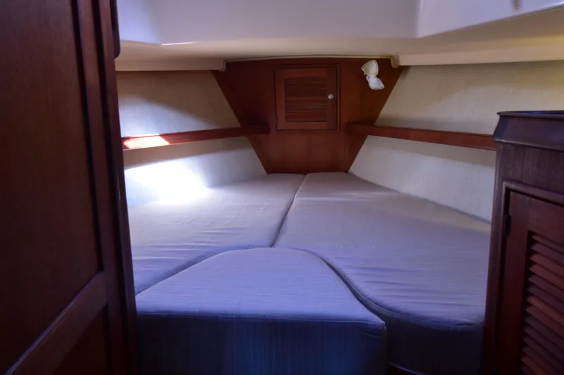 Shibumi Yacht Photos Pics 1995 Island Packet 37 sailboat interior cabin with cozy bed and wooden accents.