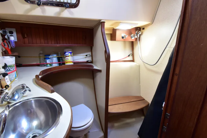 Shibumi Yacht Photos Pics 1995 Island Packet 37 yacht bathroom with sink, toilet, and shower area.