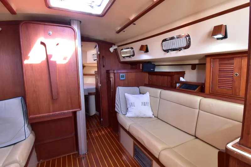 Shibumi Yacht Photos Pics Interior of 1995 Island Packet 37 sailboat with cozy seating and wooden finishes.