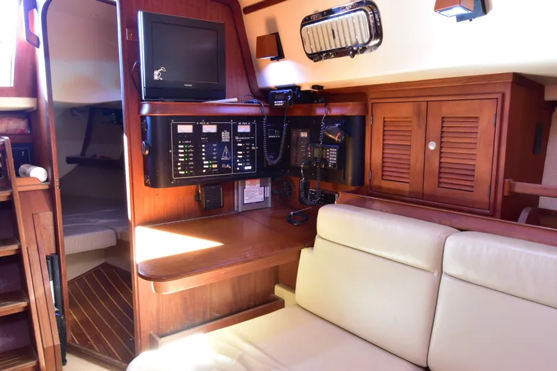Shibumi Yacht Photos Pics Interior of 1995 Island Packet 37 sailboat with navigation station and cozy seating area.