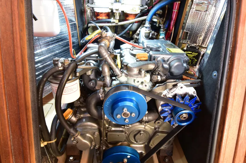 Shibumi Yacht Photos Pics Engine compartment of a 1995 Island Packet 37 sailboat, showcasing mechanical components and wiring.