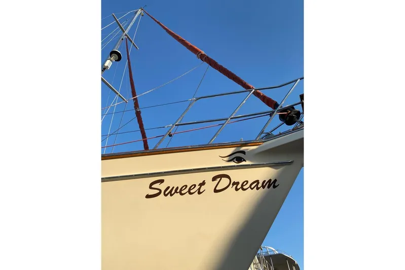 Sweet Dream Yacht Photos Pics Island Packet 485 sailboat, 2005 model, named "Sweet Dream" against clear blue sky.