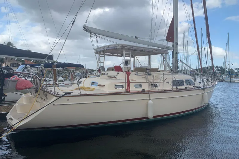 Sweet Dream Yacht Photos Pics 2005 Island Packet 485 sailboat docked in a marina under cloudy skies.
