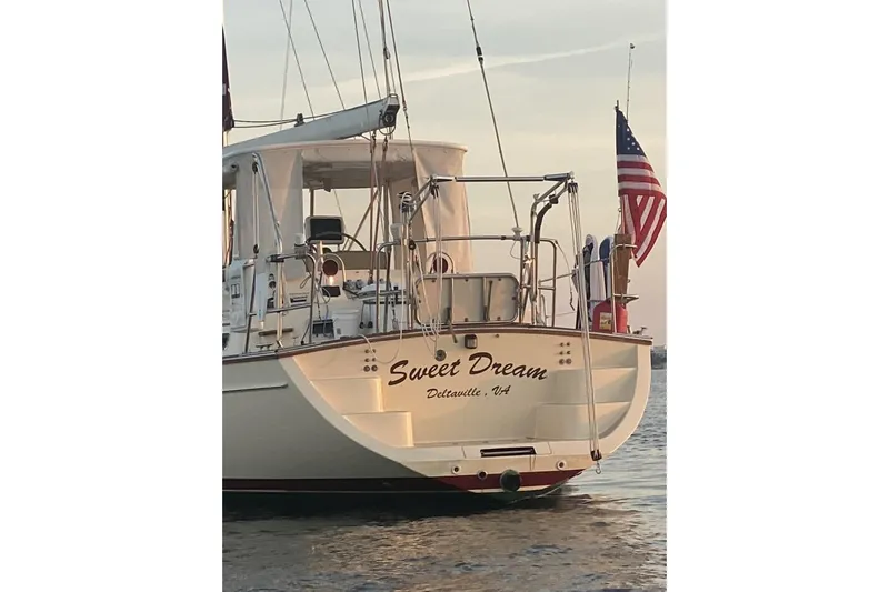 Sweet Dream Yacht Photos Pics Island Packet 485 sailboat "Sweet Dream" on water, displaying American flag, 2005 model.