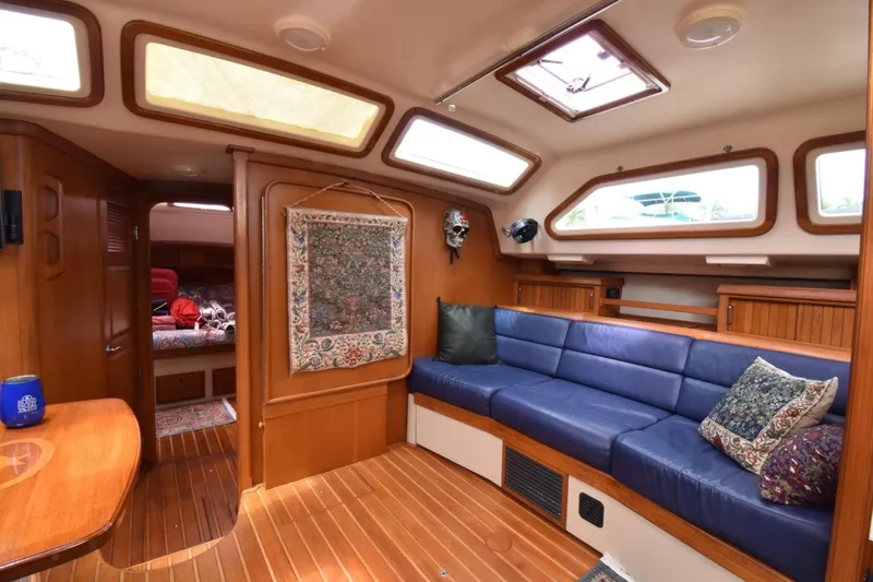 Sweet Dream Yacht Photos Pics Luxurious 2005 Island Packet 485 yacht interior with blue seating and wooden accents.