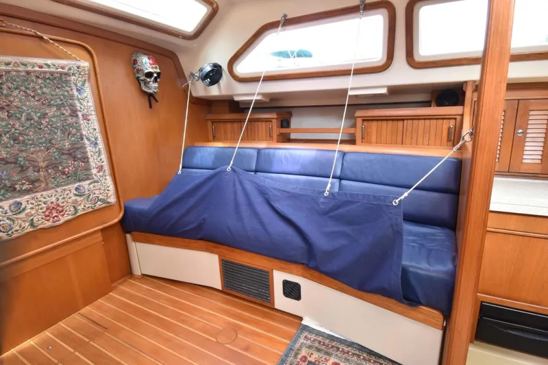 Sweet Dream Yacht Photos Pics Interior of 2005 Island Packet 485 yacht with blue seating and wooden accents.