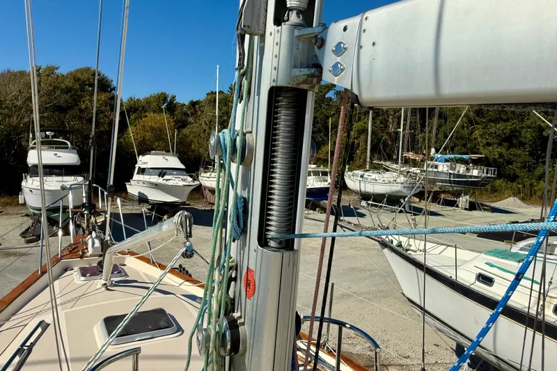 Sweet Dream Yacht Photos Pics 2005 Island Packet 485 sailboat in a boatyard with other vessels, surrounded by trees.