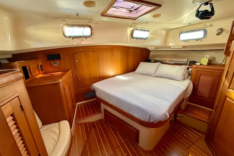 Sweet Dream Yacht Photos Pics Luxurious cabin interior of 2005 Island Packet 485 yacht with wood finish and cozy bed.