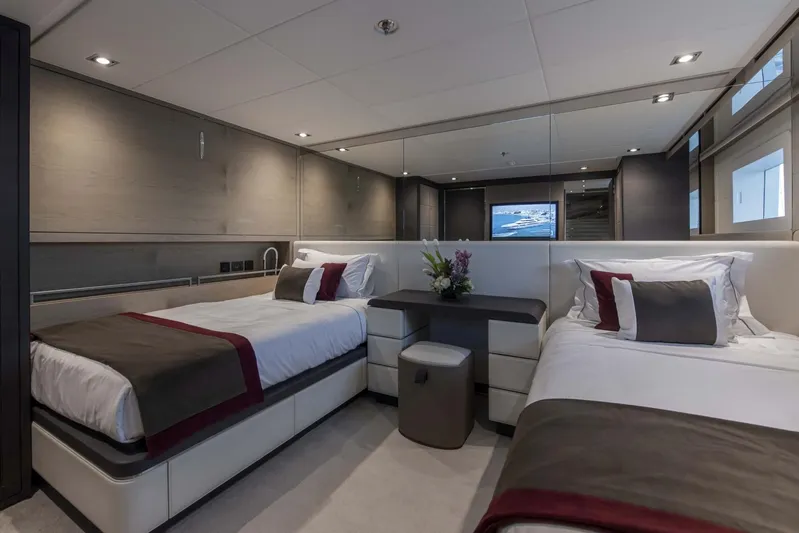 Available 2026 Yacht Photos Pics Luxurious twin bedroom on 2026 Majesty 175 yacht, featuring modern decor and elegant lighting.