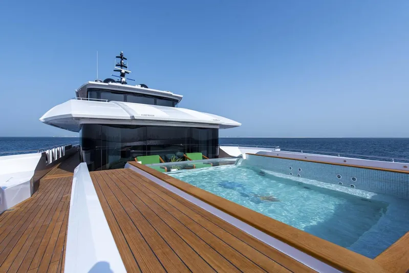 Available 2026 Yacht Photos Pics Luxurious 2026 Majesty 175 yacht with pool, cruising on open sea.