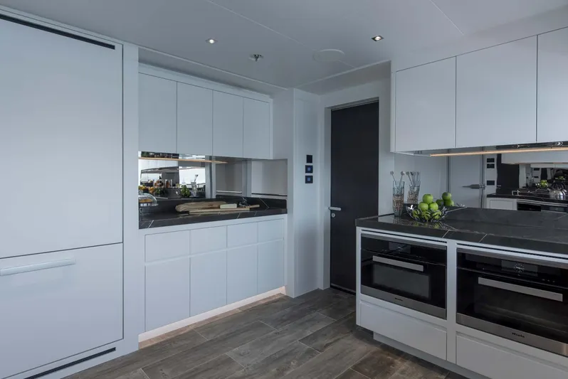 Available 2026 Yacht Photos Pics Modern kitchen interior on 2026 Majesty 175 yacht, featuring sleek cabinetry and appliances.