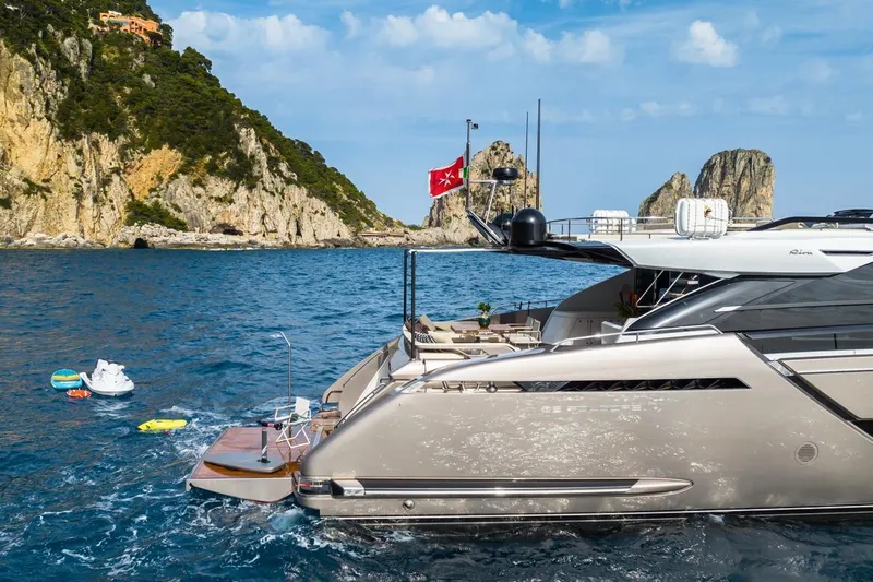 Kar Yacht Photos Pics Luxury Riva 88 Folgore yacht cruising near rocky coastline, 2021 model.