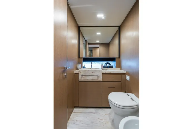 Kar Yacht Photos Pics Luxurious bathroom interior on 2021 Riva 88 Folgore yacht with modern fixtures and wood accents.