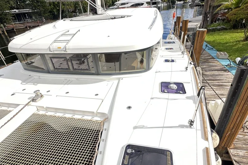 Keola Yacht Photos Pics 2022 Lagoon 40 catamaran docked, showcasing sleek design and spacious deck layout.