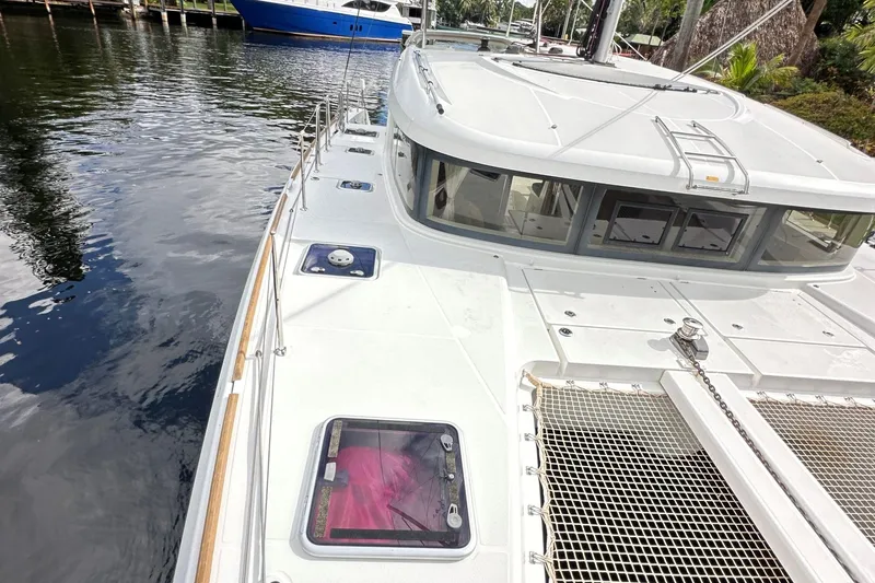 Keola Yacht Photos Pics 2022 Lagoon 40 catamaran docked, showcasing sleek design and spacious deck.