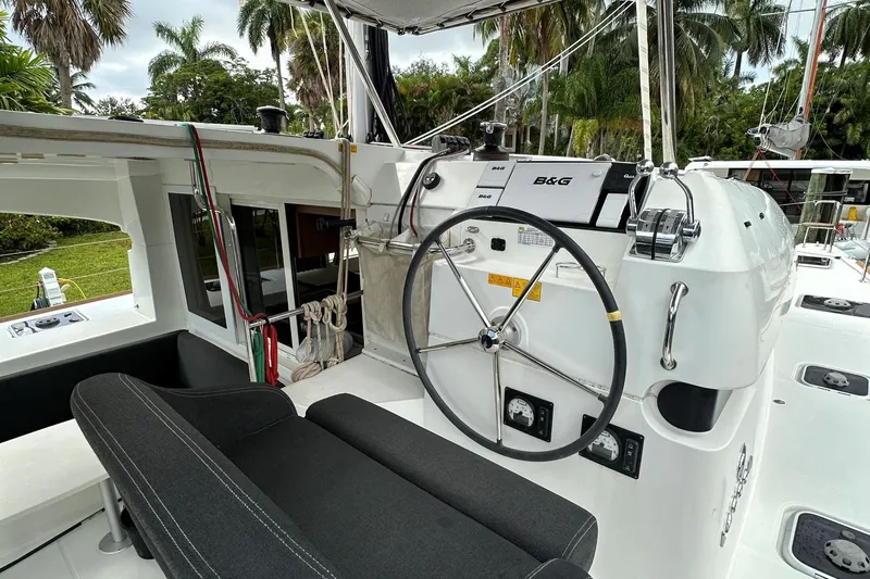 Keola Yacht Photos Pics Cockpit of 2022 Lagoon 40 catamaran with steering wheel and navigation equipment.