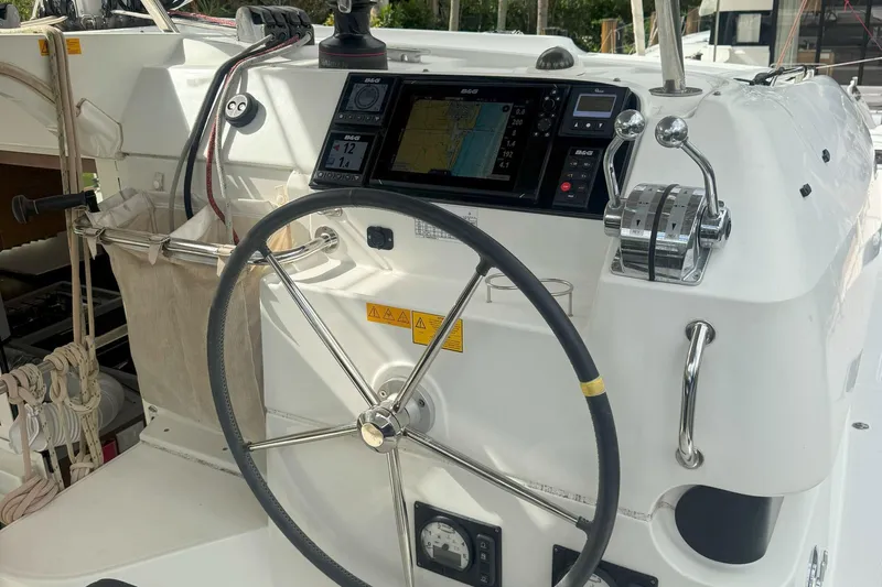 Keola Yacht Photos Pics Helm of 2022 Lagoon 40 catamaran with navigation equipment and steering wheel.